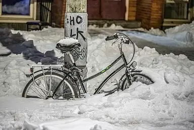 Bicycle: Bike on a snowy street in Quebec City at night